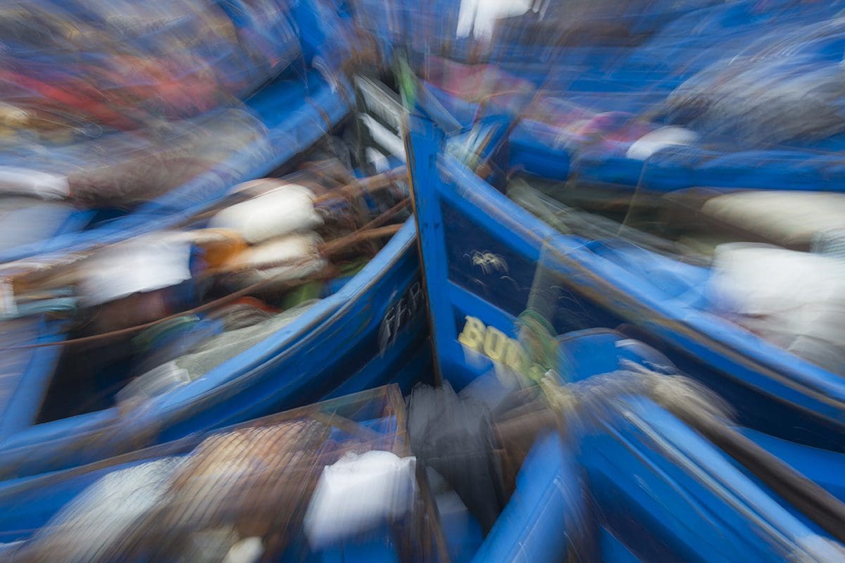 A blurry image of a group of blue boats.