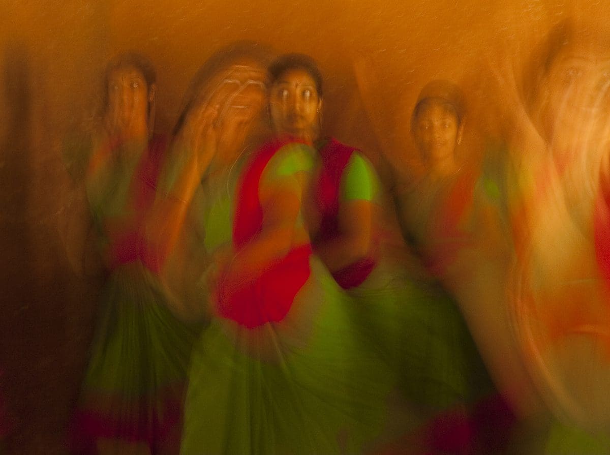 A blurry image of a group of women dancing.