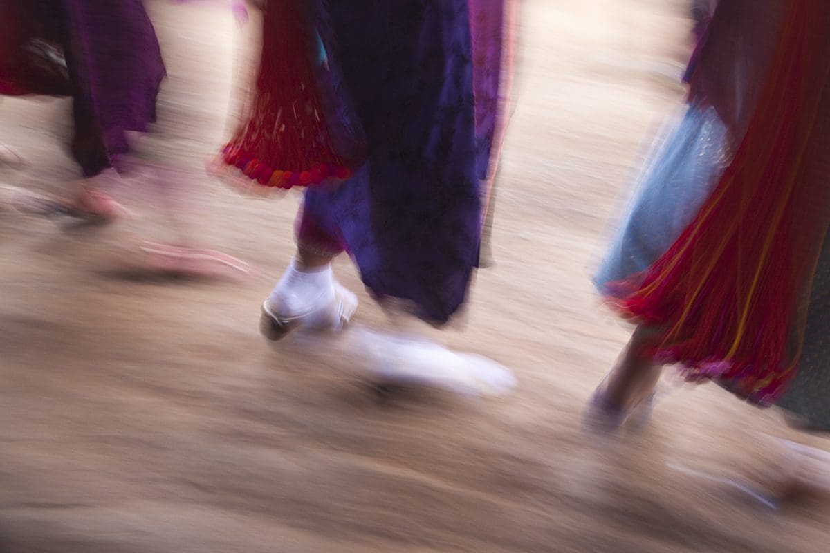 A blurry image of a group of people walking.