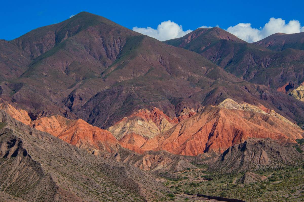 A mountain range with red, orange, yellow and green colors.