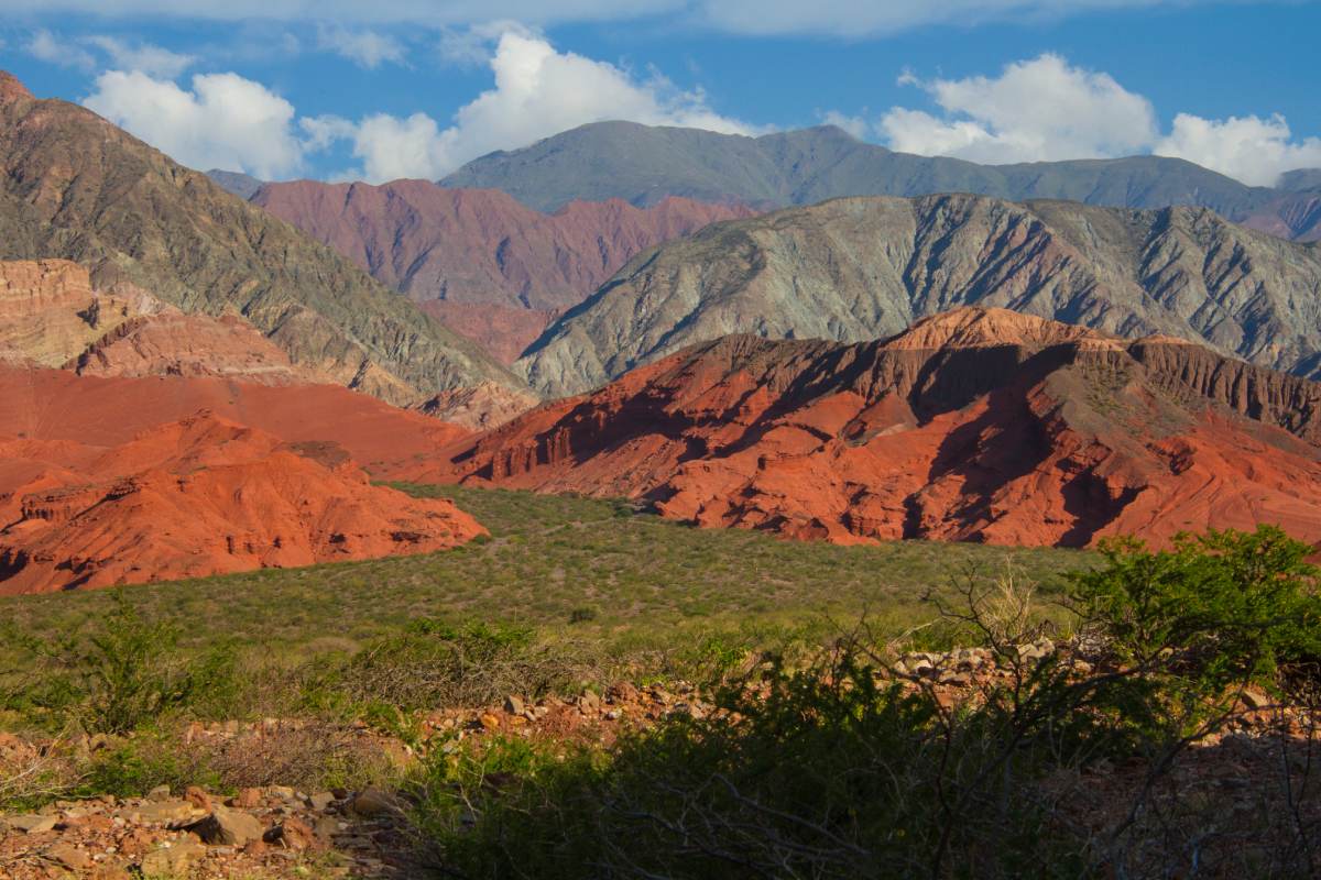 A mountain range with red rocks in the background.