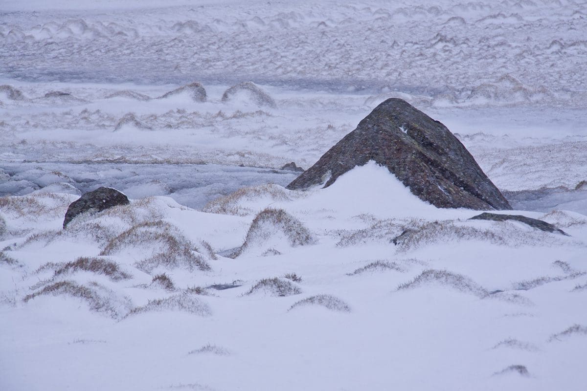 A large rock covered in snow and ice.