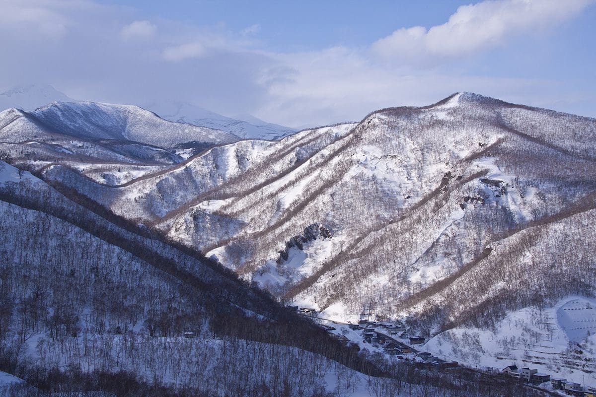 An aerial view of a mountain covered in snow.