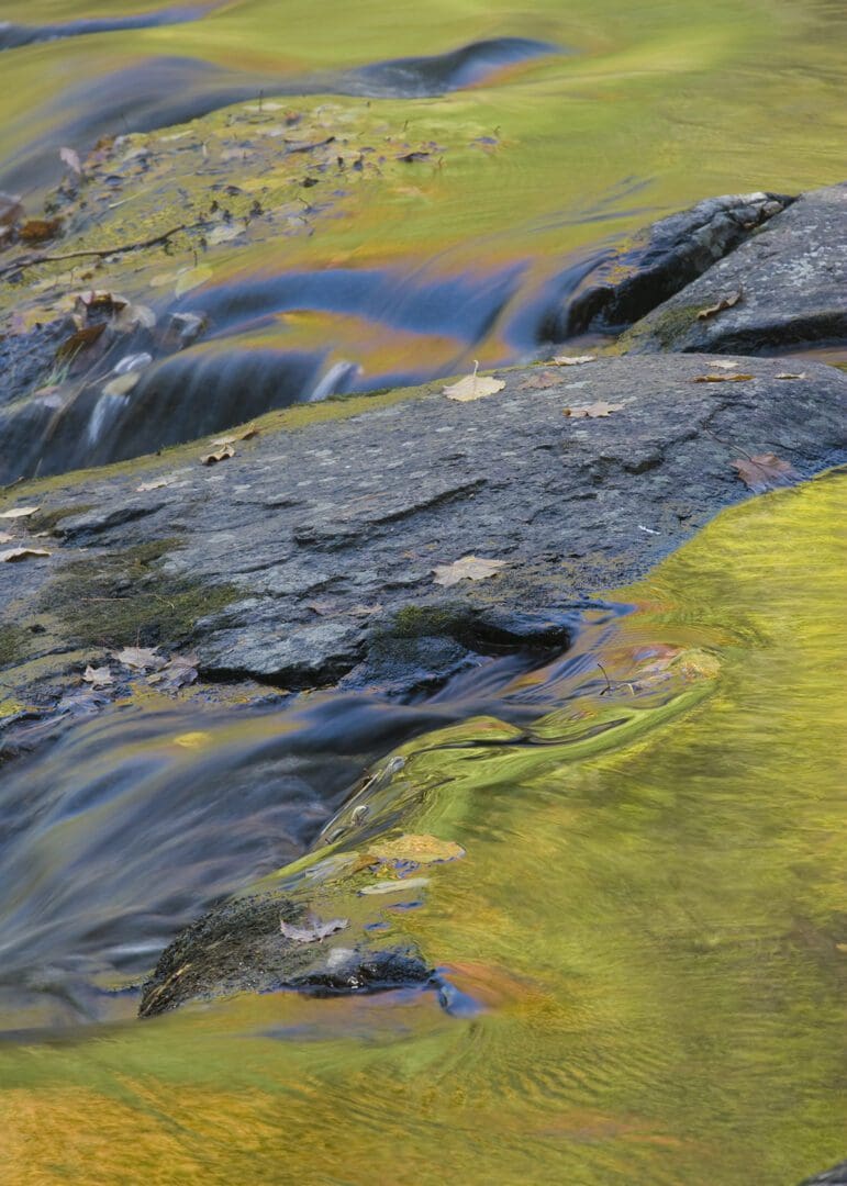 A stream of water flowing over rocks.
