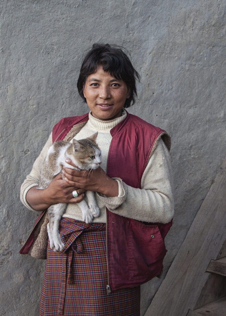 A woman holding a cat.