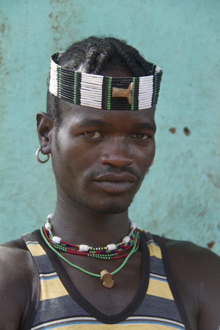 A man wearing a headdress and a necklace.