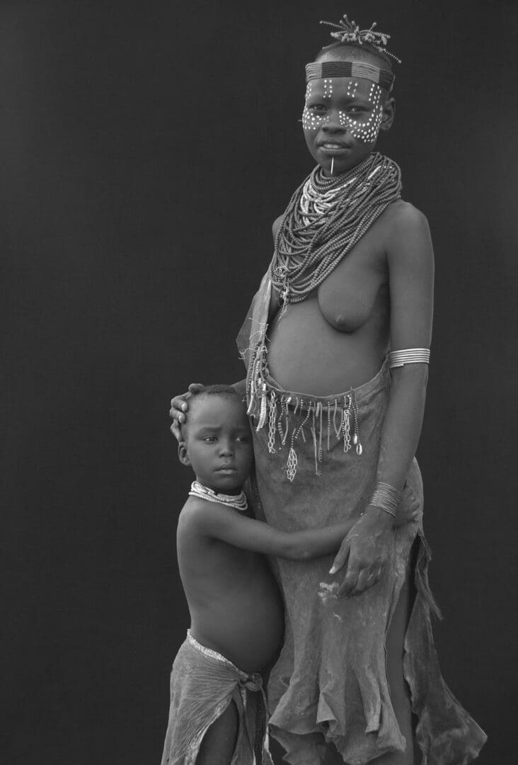 A black and white photo of an african woman and child.