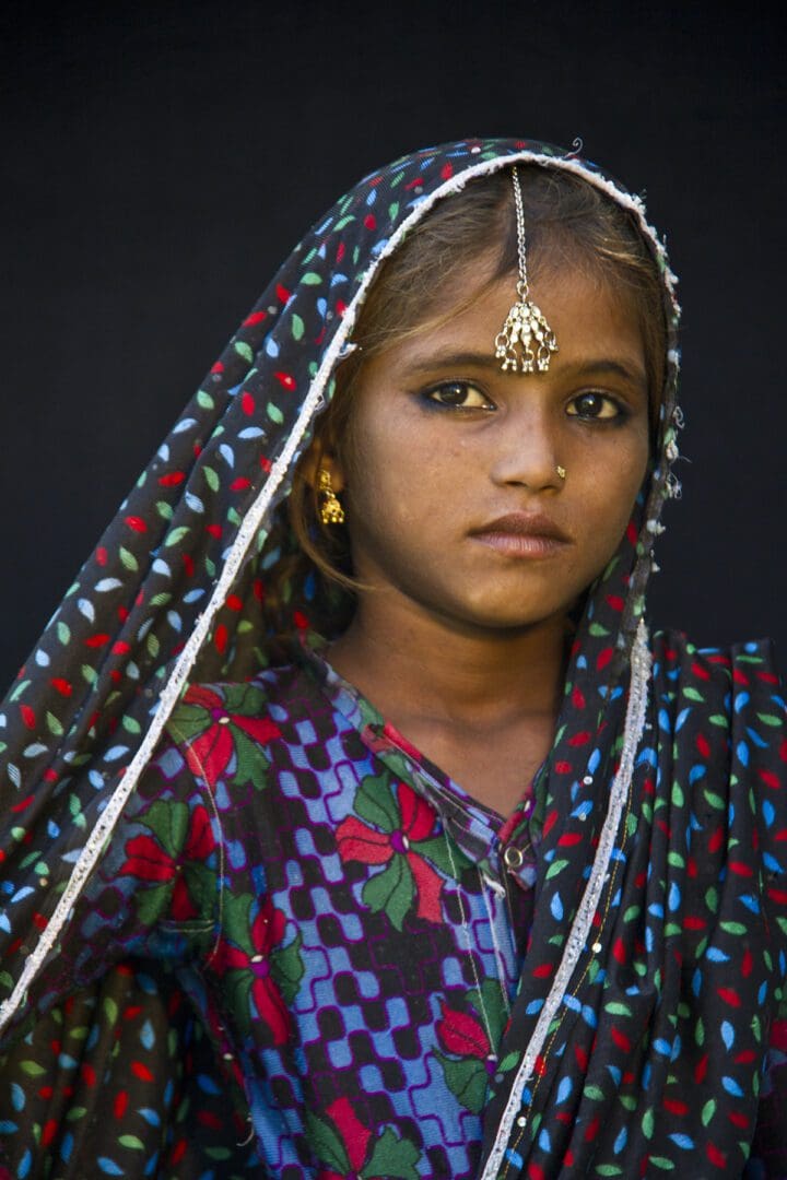 A young girl wearing a colorful sari.