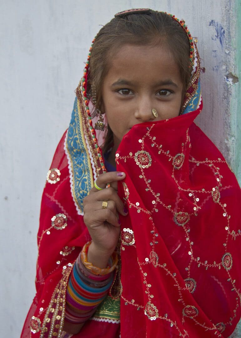 A girl wearing a red sari.