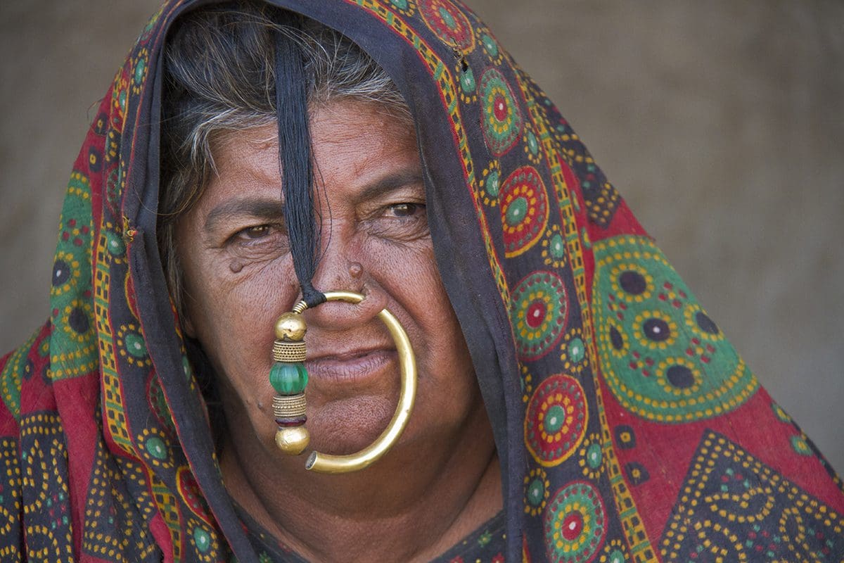 A woman with a gold ring on her nose.