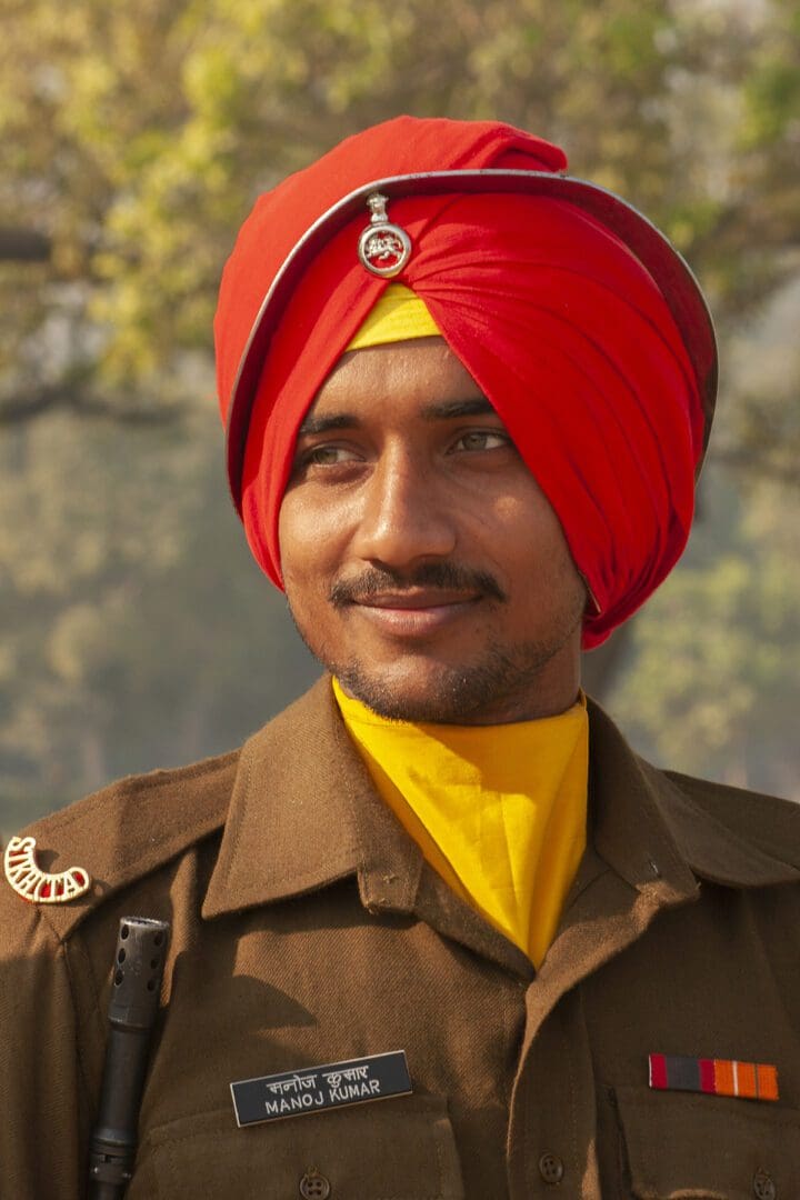 A man in uniform with a red turban.