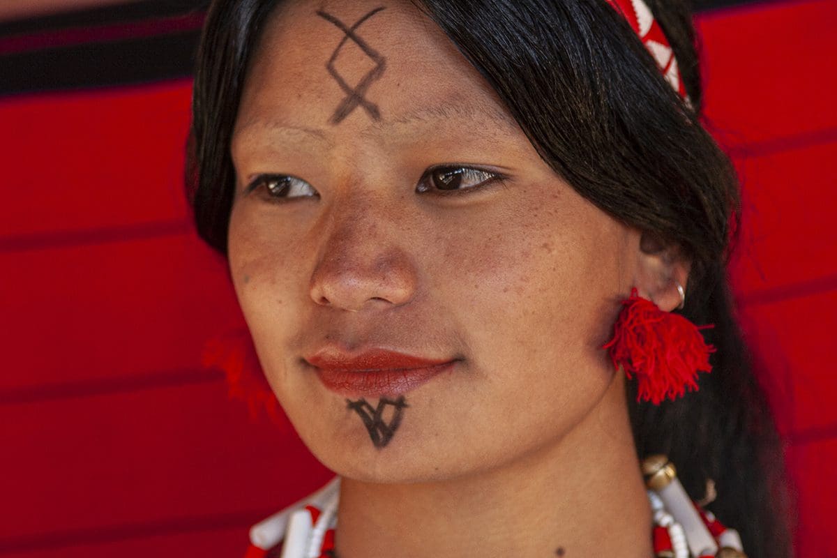 A woman with a tribal tattoo on her face.
