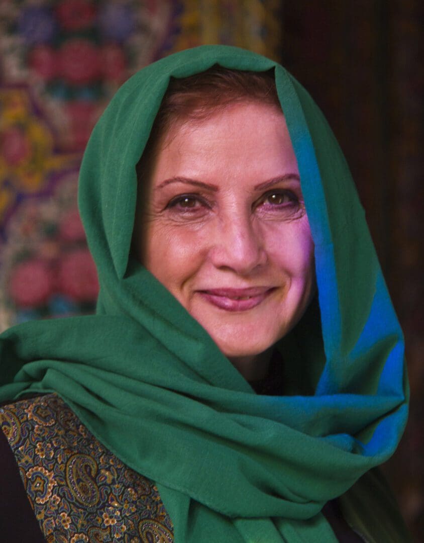 A woman wearing a green scarf.