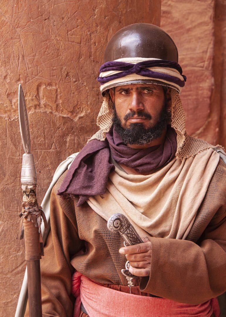 A man in a costume holding a sword.