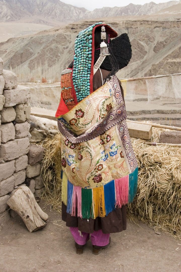 Tibetan woman carrying a bag in the mountains.