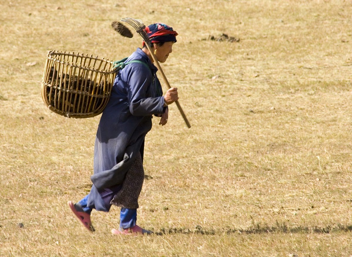 A woman carrying a basket.