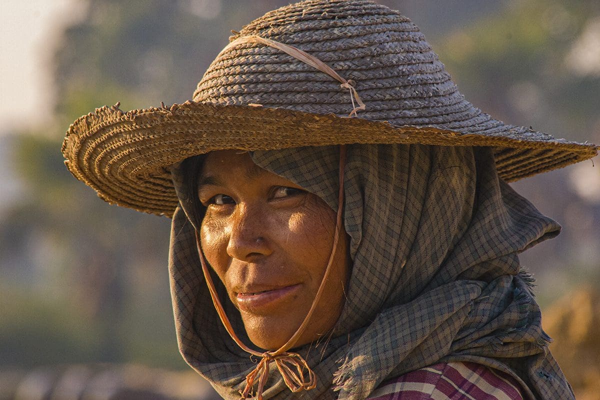 A woman wearing a straw hat.