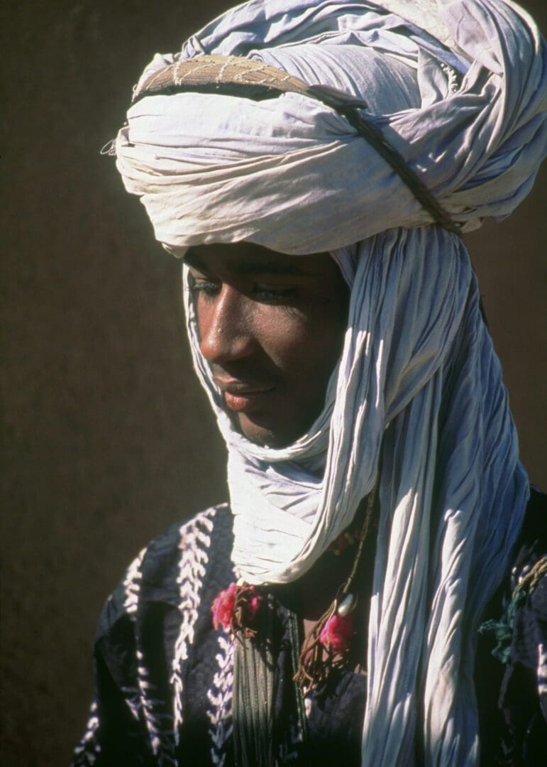 A young man wearing a white turban.