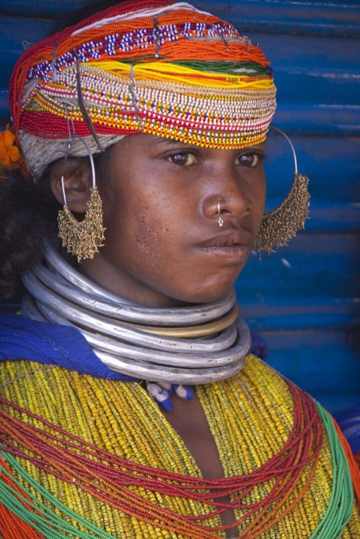 A woman wearing colorful jewelry and a turban.