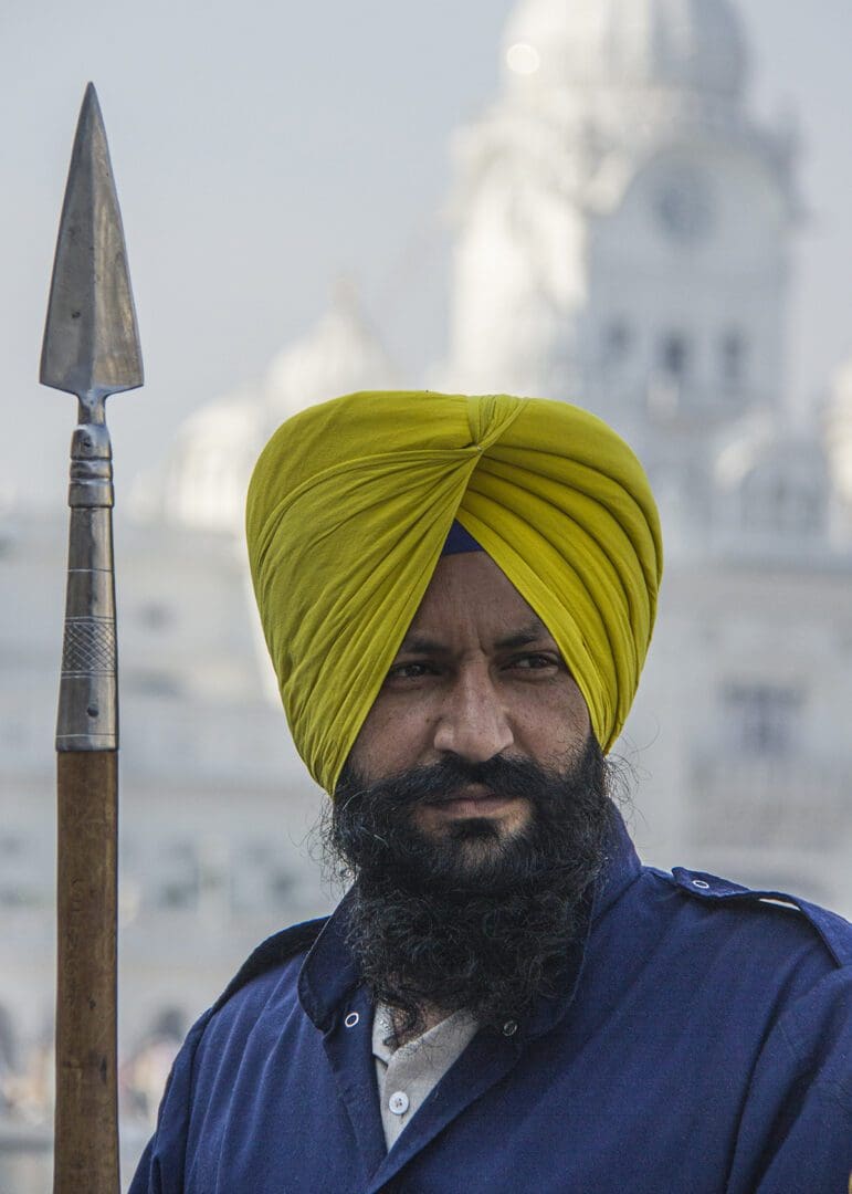 A man in a turban holding a spear.