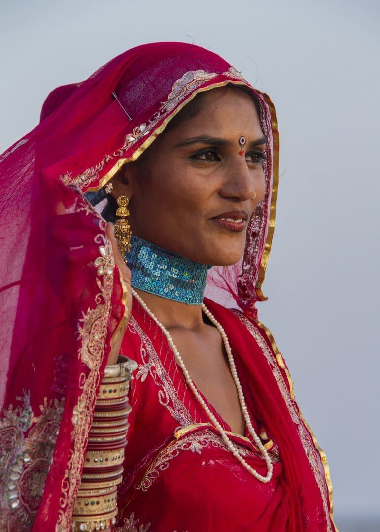 An indian woman wearing a red sari.