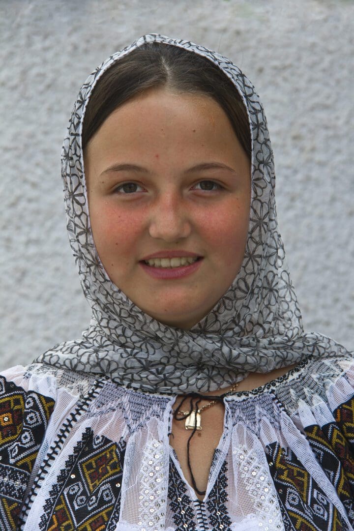 A young girl wearing a head scarf.