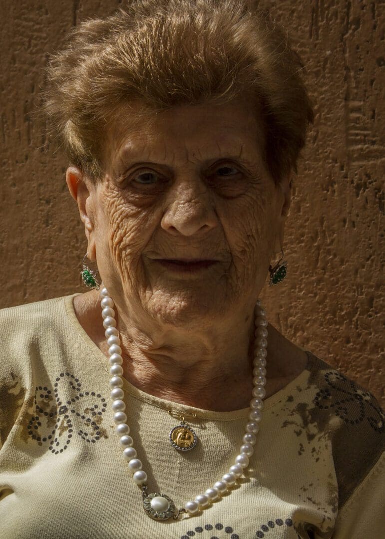 An old woman with a pearl necklace.