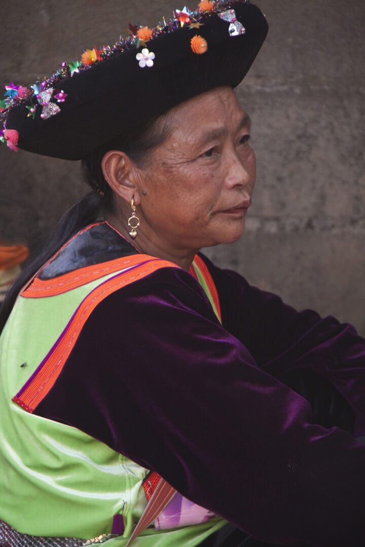 A woman wearing a colorful hat.