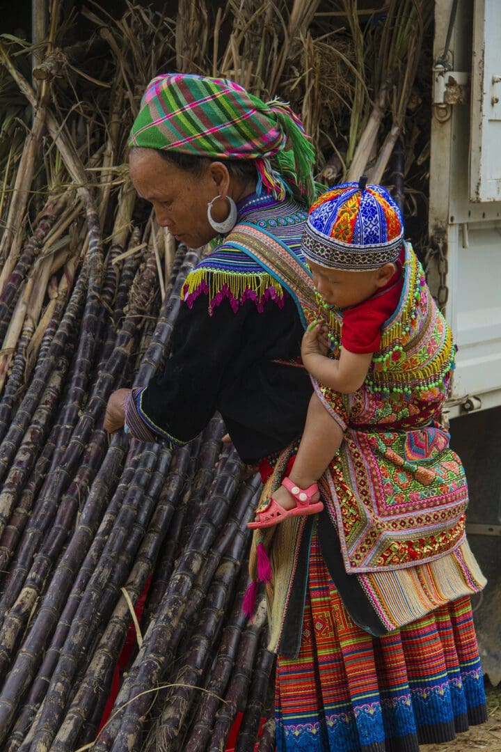 A woman carrying a child on her back.
