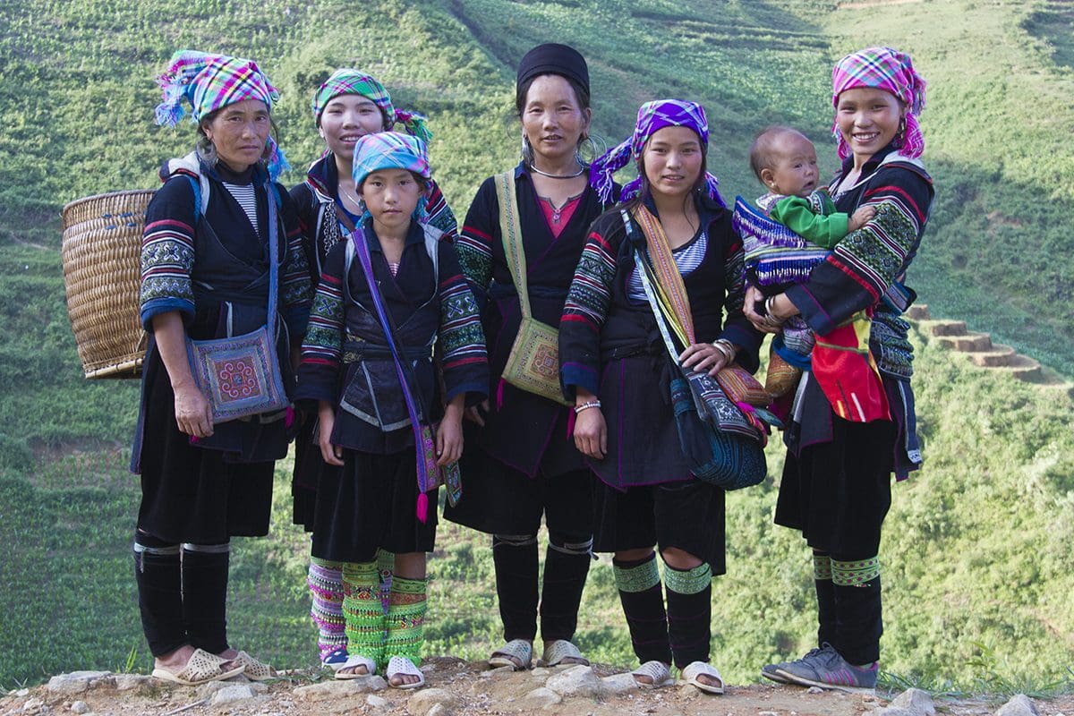 A group of women in traditional clothing posing for a photo.