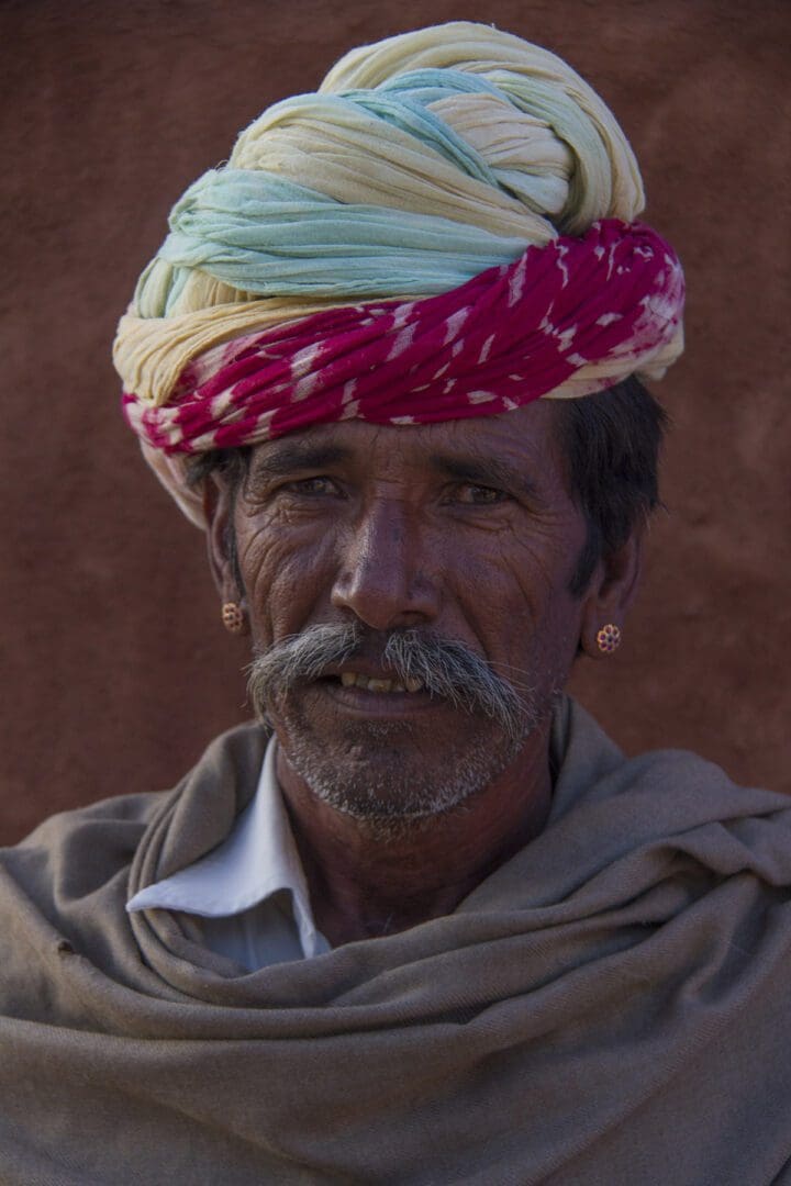 An indian man wearing a colorful turban.