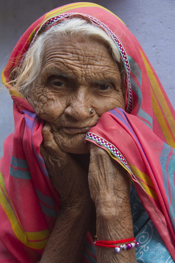 An old woman wearing a colorful sari.