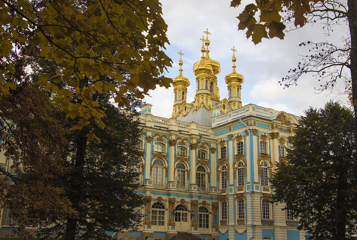 A blue and gold building with golden domes.