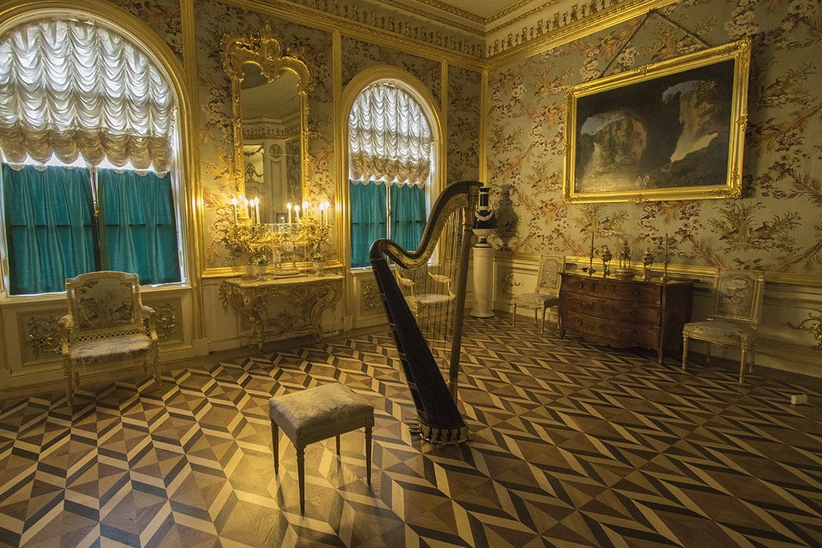 An ornately decorated room with a harp.