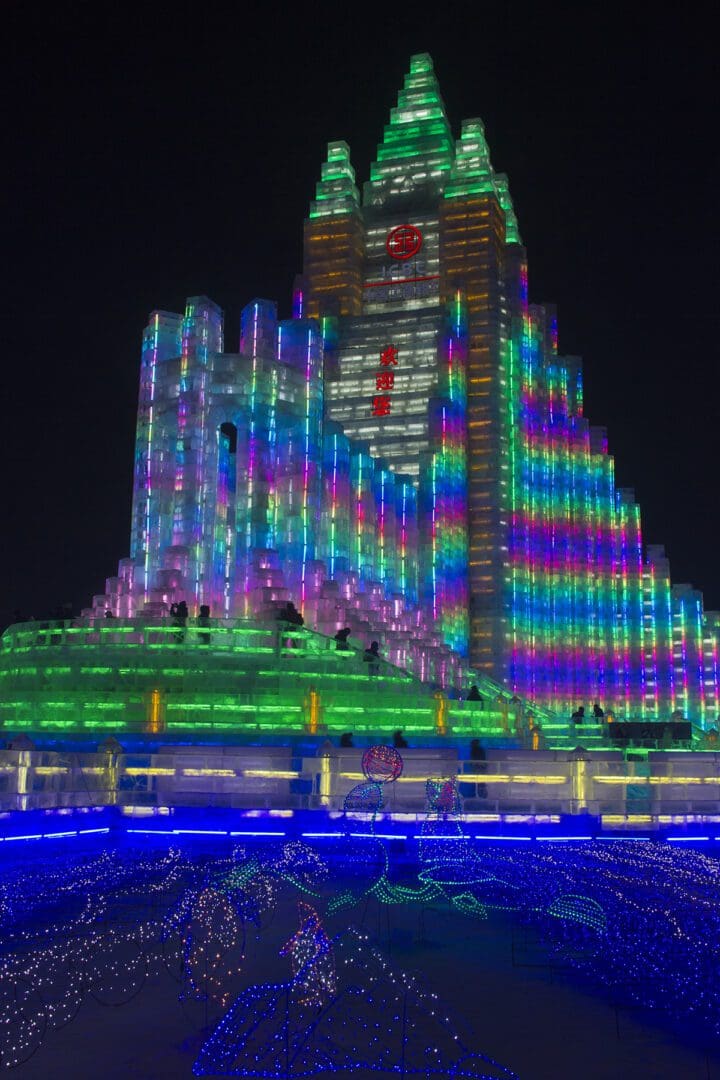 A large building lit up with colorful lights.