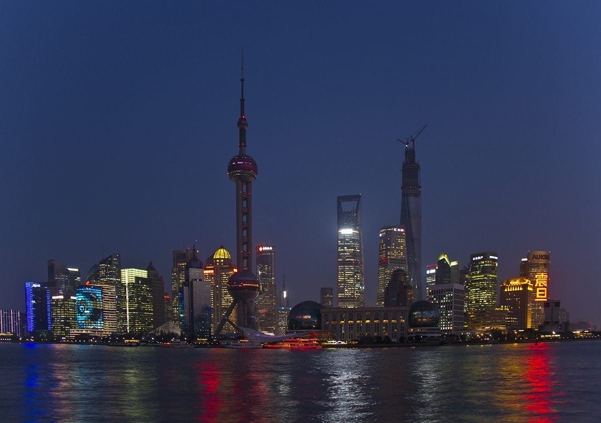 The skyline of shanghai is lit up at night.