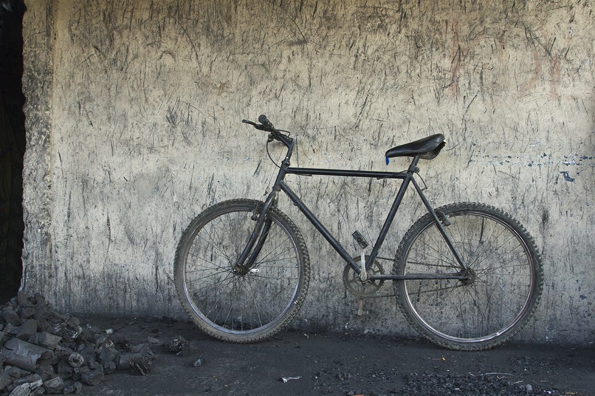A bike leaning against a wall.