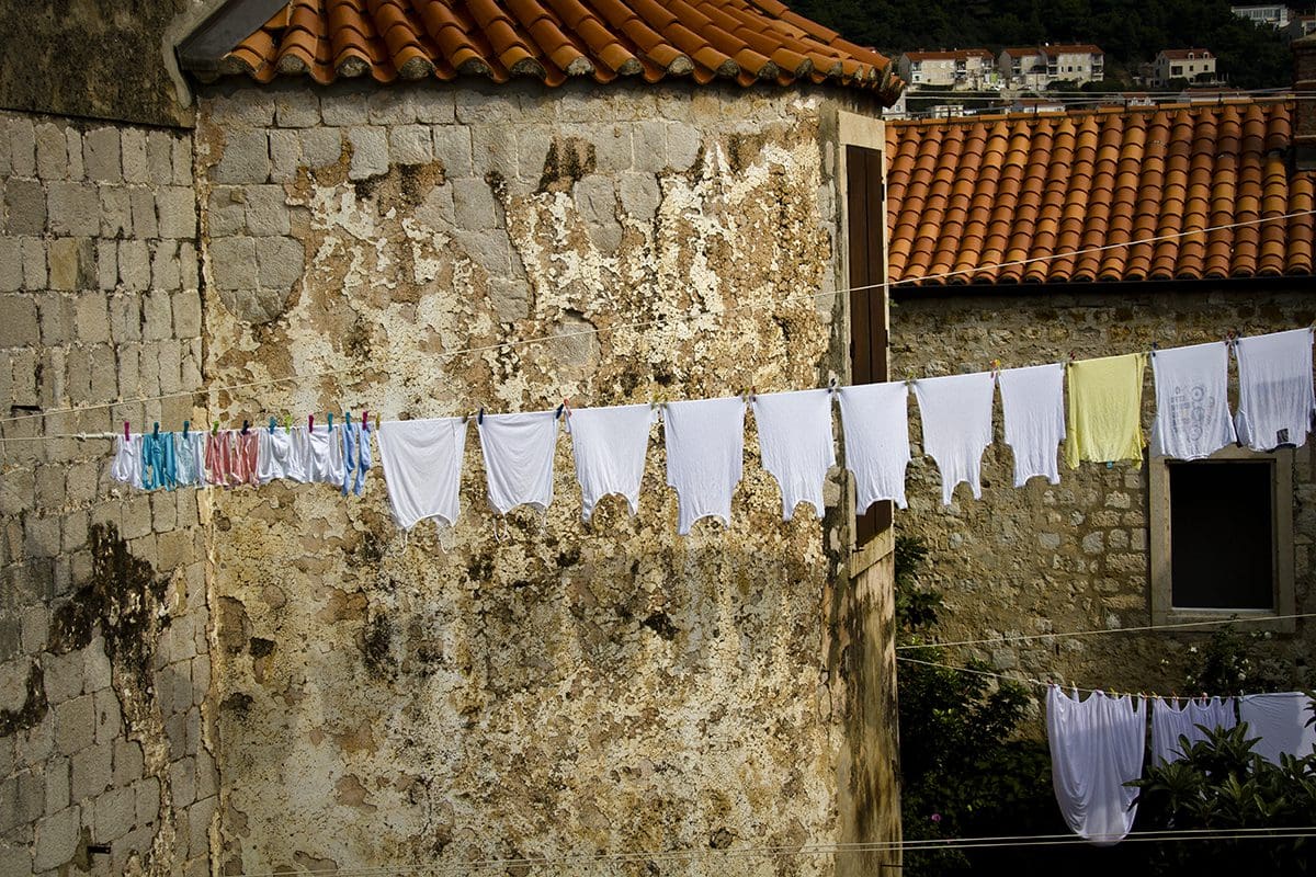 A line of clothes hanging from a building.