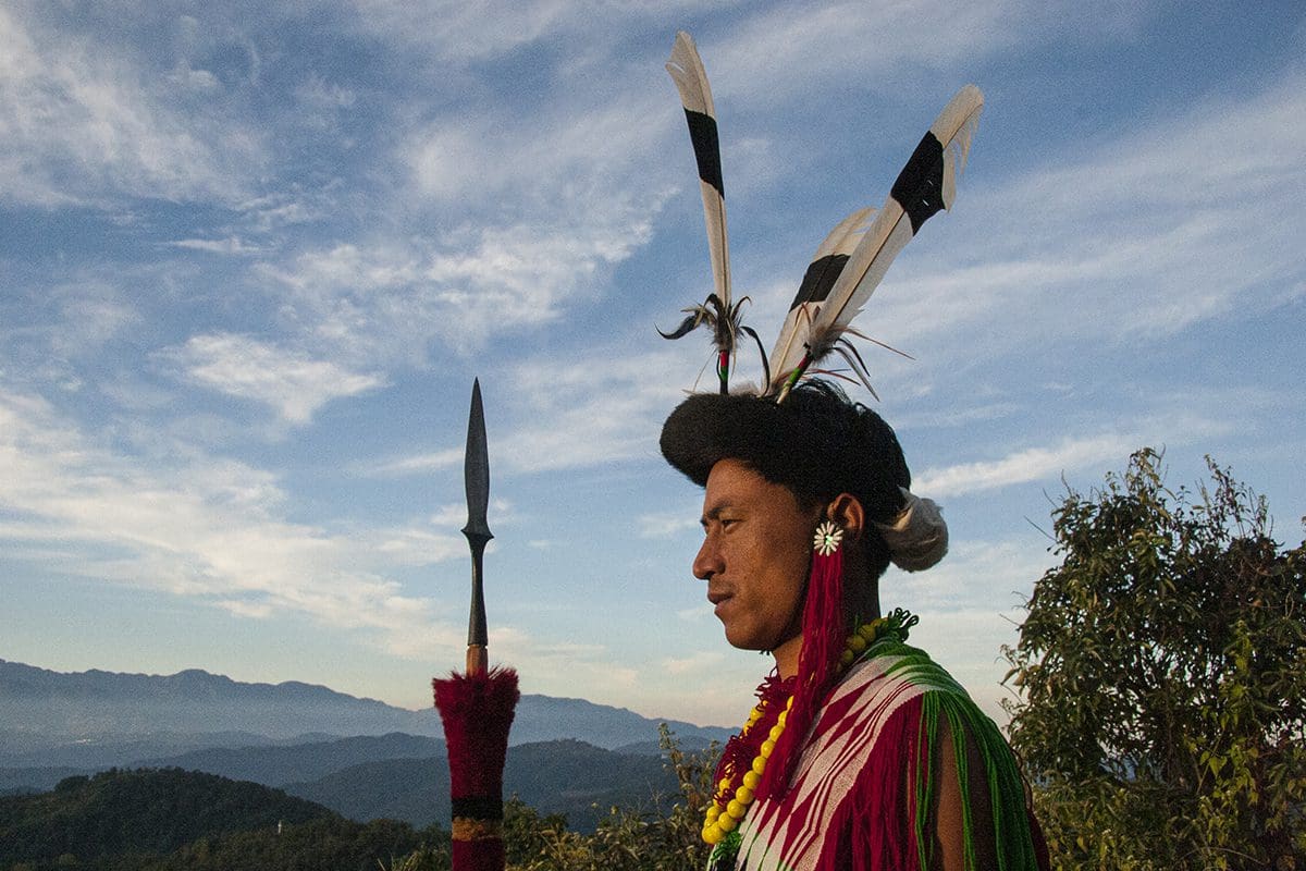 A man with a feathered headdress holding a sword.