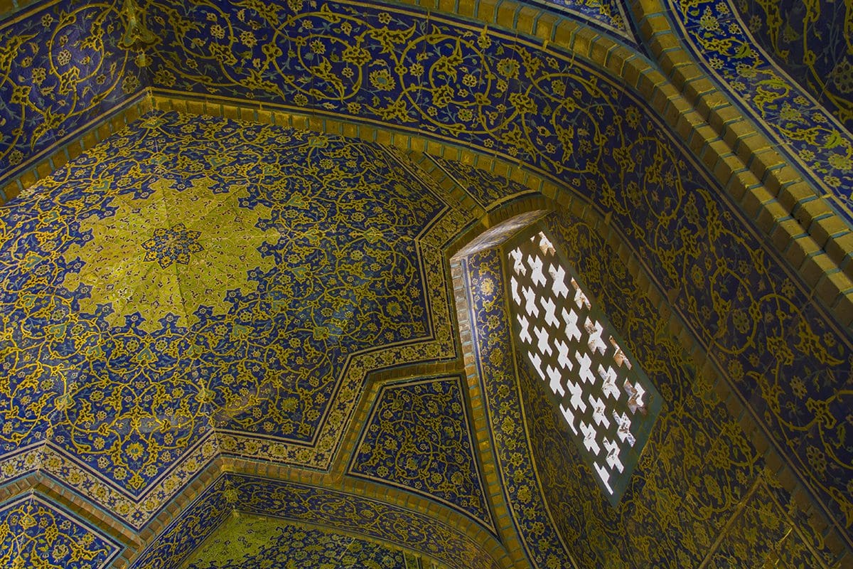 A blue and gold tiled ceiling in a mosque.