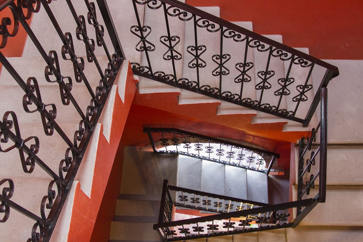 A staircase with wrought iron railings.