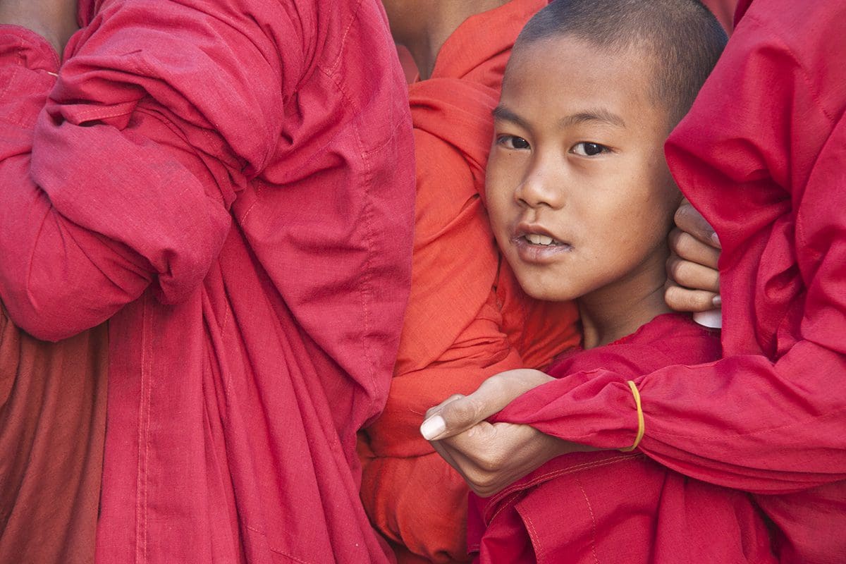 A group of young monks in red robes.