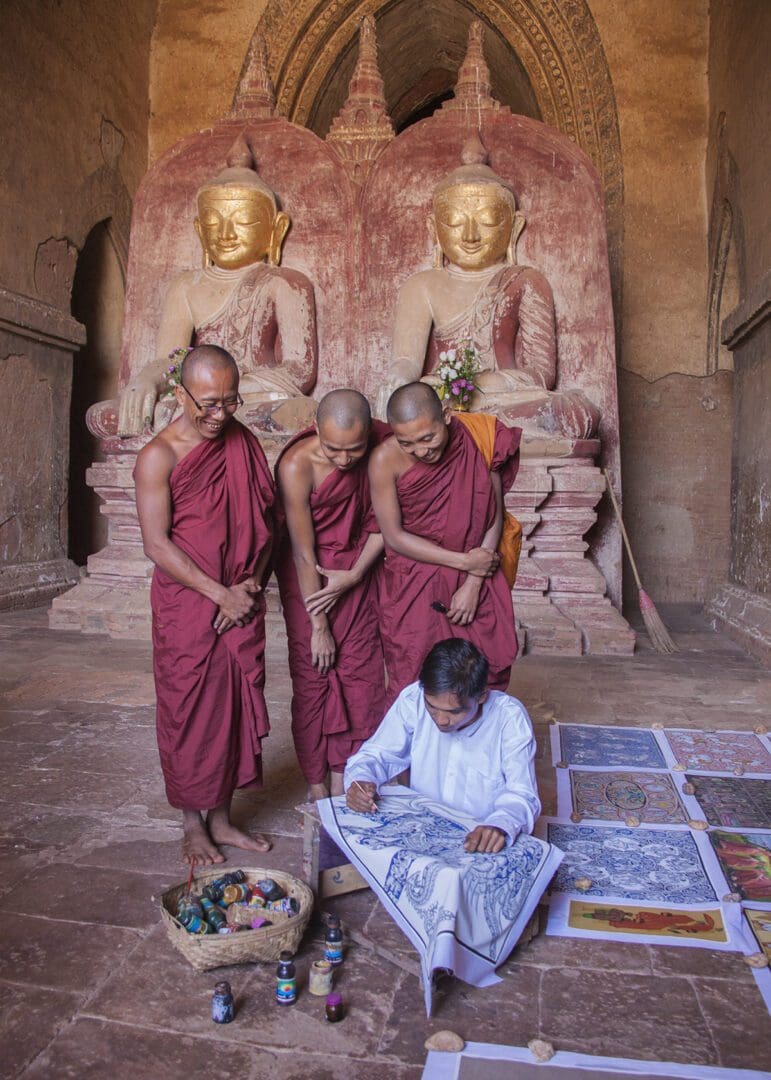 A group of buddhist monks working on a map.