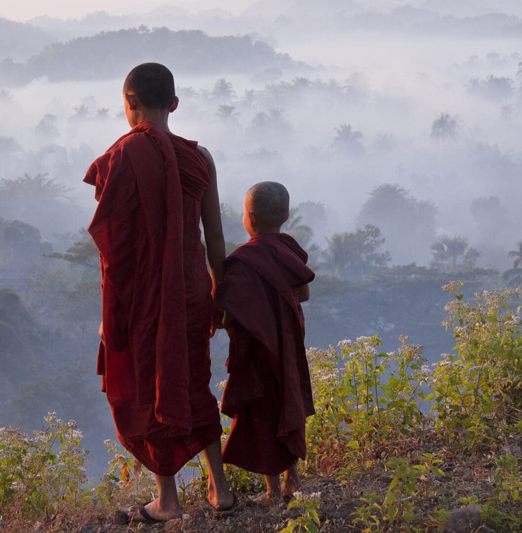 Two young monks in red robes.