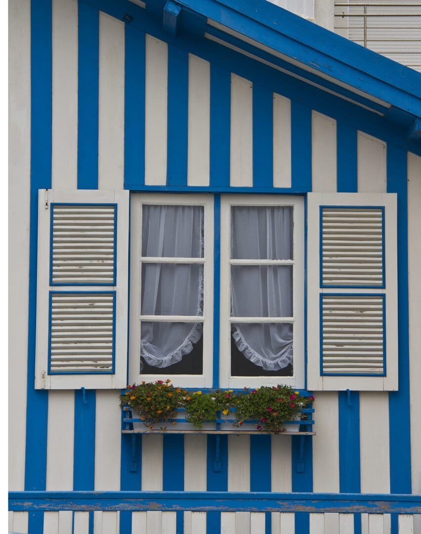 A blue and white striped building with a window.