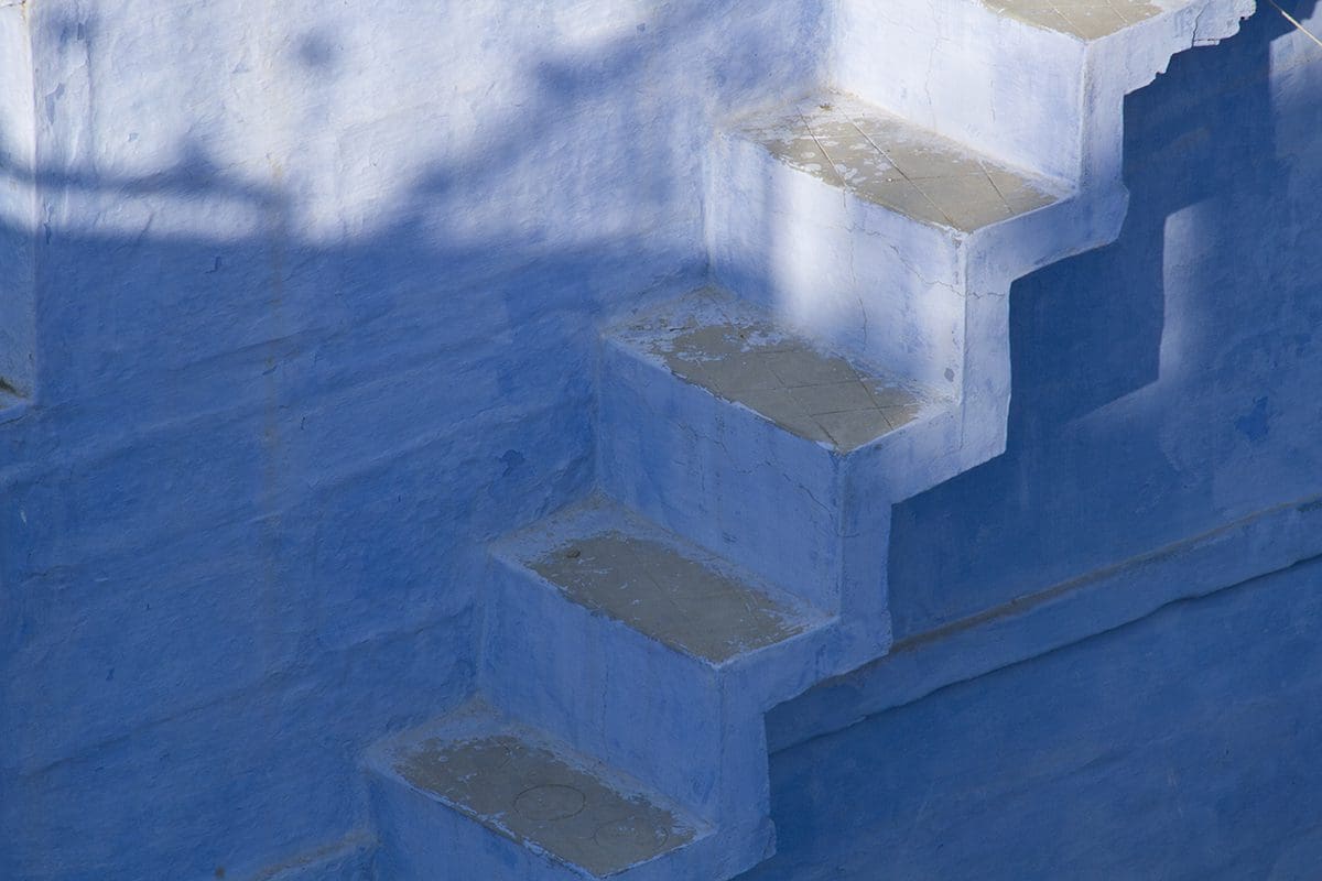 Stairs leading up to a blue building in jodhpur, india.