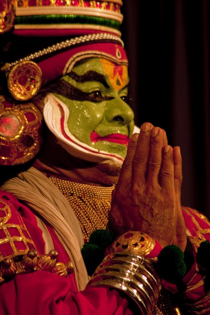 An indian dancer in a green costume.