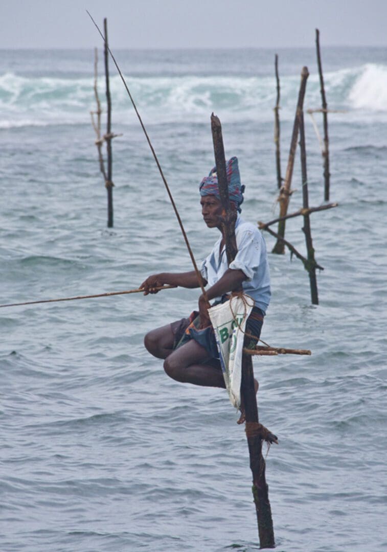 A man is fishing with a pole in the water.