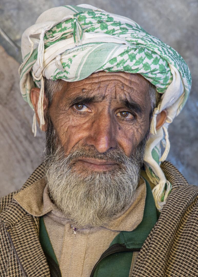 A man wearing a green and white turban.