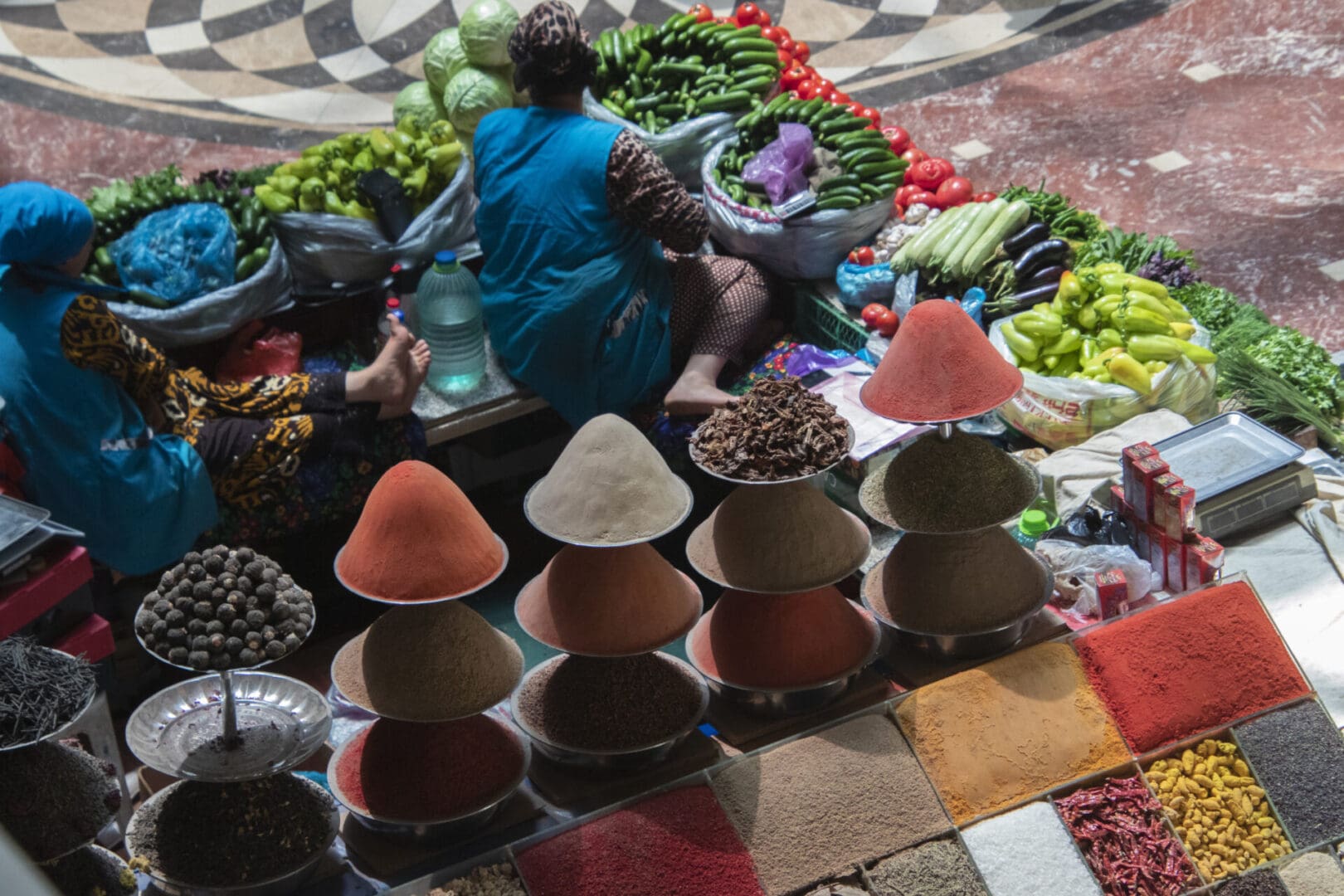 A woman sells spices in a market in morocco.